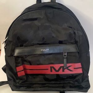 This is a black and red Michael Kors backpack